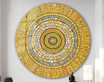 May include: A circular mosaic artwork, predominantly yellow and orange, with a concentric pattern. The design incorporates small, irregularly shaped tiles in shades of yellow, orange, brown, blue and white. The mosaic is a decorative wall hanging, suitable for interior decor.