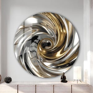 May include: A circular wall art piece with a swirling design in metallic silver and gold. The artwork has a central spiral and a marble-effect background. The piece is mounted on a white wall. The overall effect is modern and decorative.