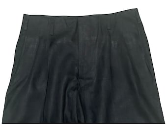 May include: Black pleated pants with a smooth, slightly textured fabric.