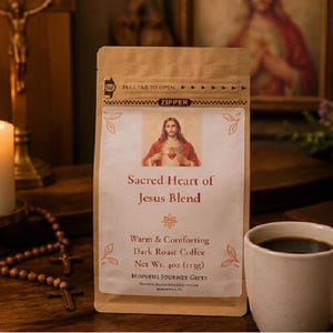 May include: A bag of "Sacred Heart of Jesus Blend" dark roast coffee, with an image of Jesus. The bag is next to a white mug filled with coffee, a lit candle, and a rosary. The bag weighs 4 oz.