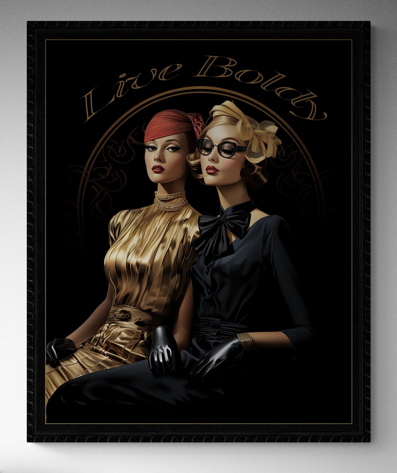 May include: A framed art print featuring two women in vintage attire. One wears a gold dress and red hat, the other a black dress and glasses. The words "Live Bold" are arched above them in gold script against a black background.