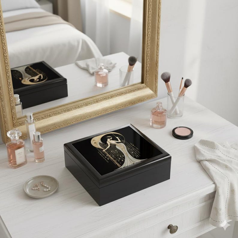 Black Box Construction Art Deco Design Woman Figure Illustration Gold Accent Details Glossy Finish Surface Elegant Jewelry Storage Vintage Style Appearance Decorative Keepsake Container Dresser Top Organizer Vanity Accessory Display Luxury
