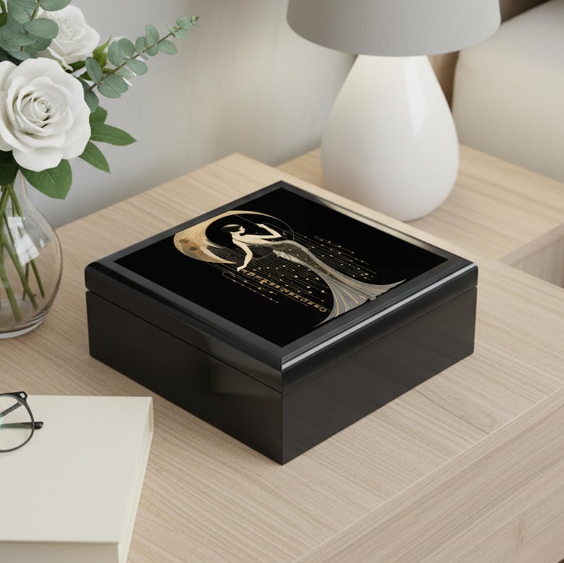Black Box Construction Art Deco Design Woman Figure Illustration Gold Accent Details Glossy Finish Surface Elegant Jewelry Storage Vintage Style Appearance Decorative Keepsake Container Dresser Top Organizer Vanity Accessory Display Luxury