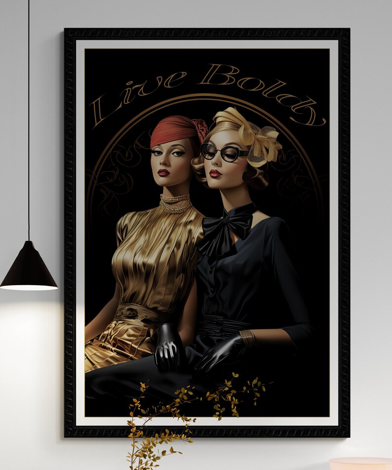 May include: A framed art print featuring two women in vintage attire. One wears a gold dress and red hat, the other a black dress and glasses. The words "Live Bold" are arched above them in gold.