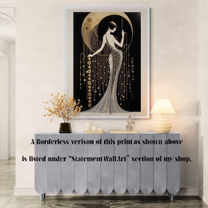 May include: A framed wall art print featuring a stylised figure in a long gown standing before a large golden crescent moon against a black background, with hanging gold circular accents and vertical lines, displayed above a light blue sideboard.