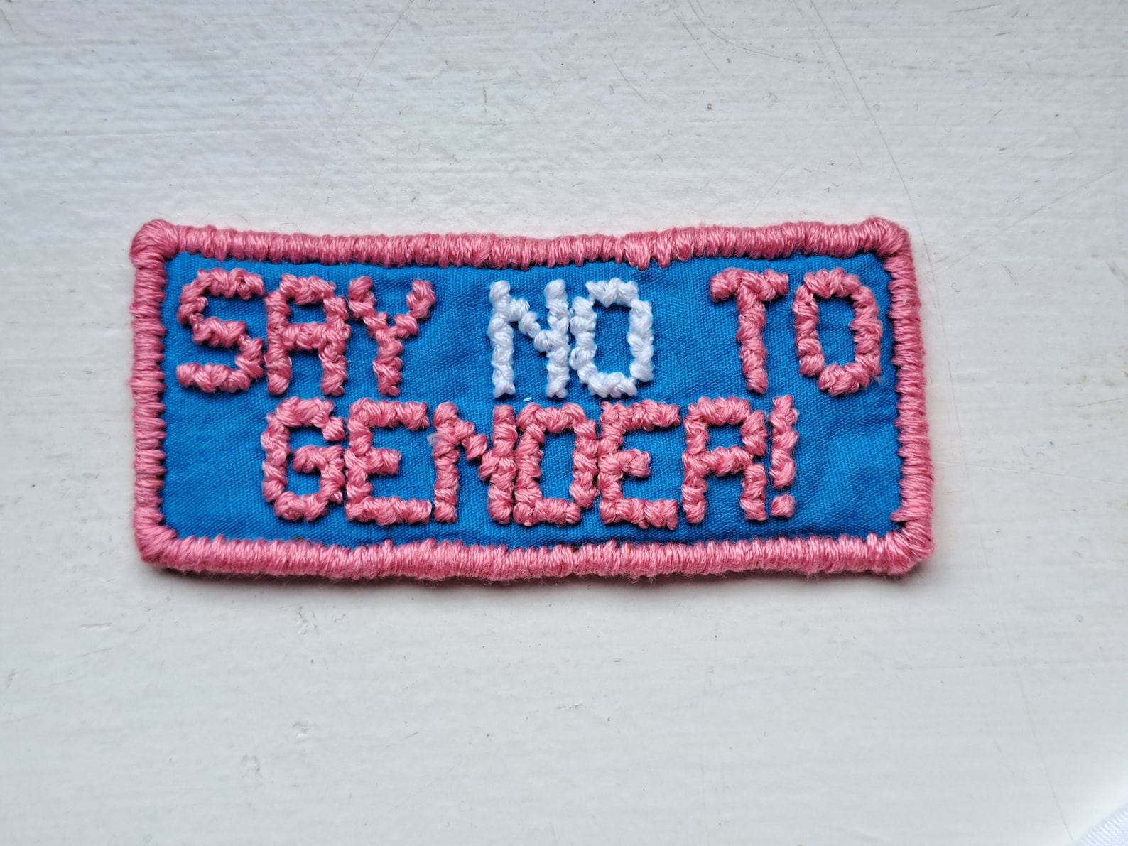 Say No To Gender cross-stitched patch in trans colours