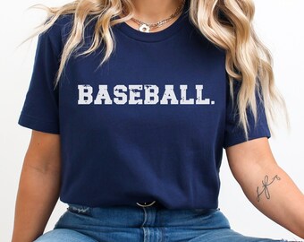May include: A navy blue t-shirt with the word "BASEBALL" printed in white on the front. The text has a distressed, vintage look.