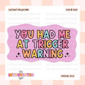May include: A pink digital download graphic with the text "You had me at trigger warning" in colorful letters with black outlines and glitter accents. The text "The Introverted Type" is at the bottom of the graphic.