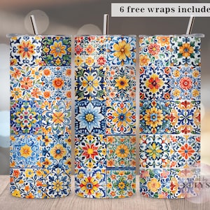Può includere: Tre bicchieri in acciaio inossidabile con colorati motivi floreali a piastrelle in blu, giallo e arancione. Ogni bicchiere ha una cannuccia d'argento e il testo "6 free wraps included". I bicchieri sono su una superficie di legno.