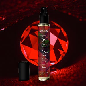 May include: A perfume bottle with a black cap and a spray nozzle. The bottle is labeled "ruby red" and contains 0.33 fl oz (10 ml) of liquid. The background features a large, faceted red gemstone.
