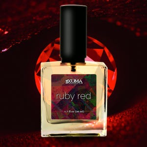 May include: A square perfume bottle with a black cap, labeled "ruby red." The label features the text "EXUMA FRAGRANCE CO." and "ruby red" over a colorful geometric design. The bottle contains 1.7 fl oz (50 ml) of perfume.