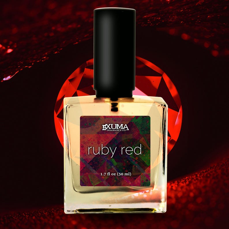 May include: A square perfume bottle with a black cap, labeled "ruby red." The label features the text "EXUMA FRAGRANCE CO." and "ruby red" over a colorful geometric design. The bottle contains 1.7 fl oz (50 ml) of perfume.