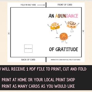 May include: Printable card with a white background and black border. The card features a cartoon illustration of three cinnamon rolls with faces and arms. The text "An Abundance of Gratitude" is written in pink and black letters. The card is designed to be folded in half.
