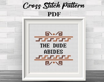 May include: Cross stitch pattern PDF for a design that says "The Dude Abides" in a brown and black font with a geometric border.