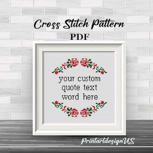 May include: Cross stitch pattern PDF with a white frame, featuring a floral wreath with red roses and green leaves. The text "your custom quote text word here" is centered within the wreath.