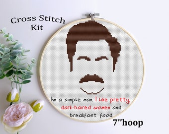 May include: Cross stitch kit featuring a brown silhouette of a man with a mustache and the text "I'm a simple man. I like pretty, dark-haired women and breakfast food." The kit is for a 7-inch hoop.