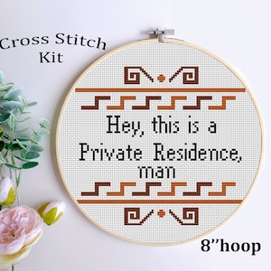 May include: Cross stitch kit featuring a white fabric with brown and black embroidery. The design reads "Hey, this is a Private Residence, man". The fabric is mounted in an 8-inch wooden hoop.