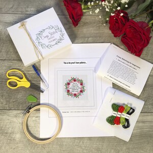 May include: Cross stitch kit for beginners with a floral design and the text "This is the proof I have patience... I have the patience to stitch something 1,000 times". The kit includes embroidery floss in green, red, and black, a piece of Aida cloth, a needle, and a hoop.