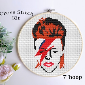 May include: Cross stitch kit featuring a portrait of David Bowie in his iconic Aladdin Sane makeup. The kit includes a 7-inch hoop and all the materials needed to complete the project.