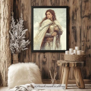 May include: A framed painting of a woman in a white cloak and armor holding a sword. She is standing in a snowy landscape. The painting is framed in black and is hanging on a wooden wall.