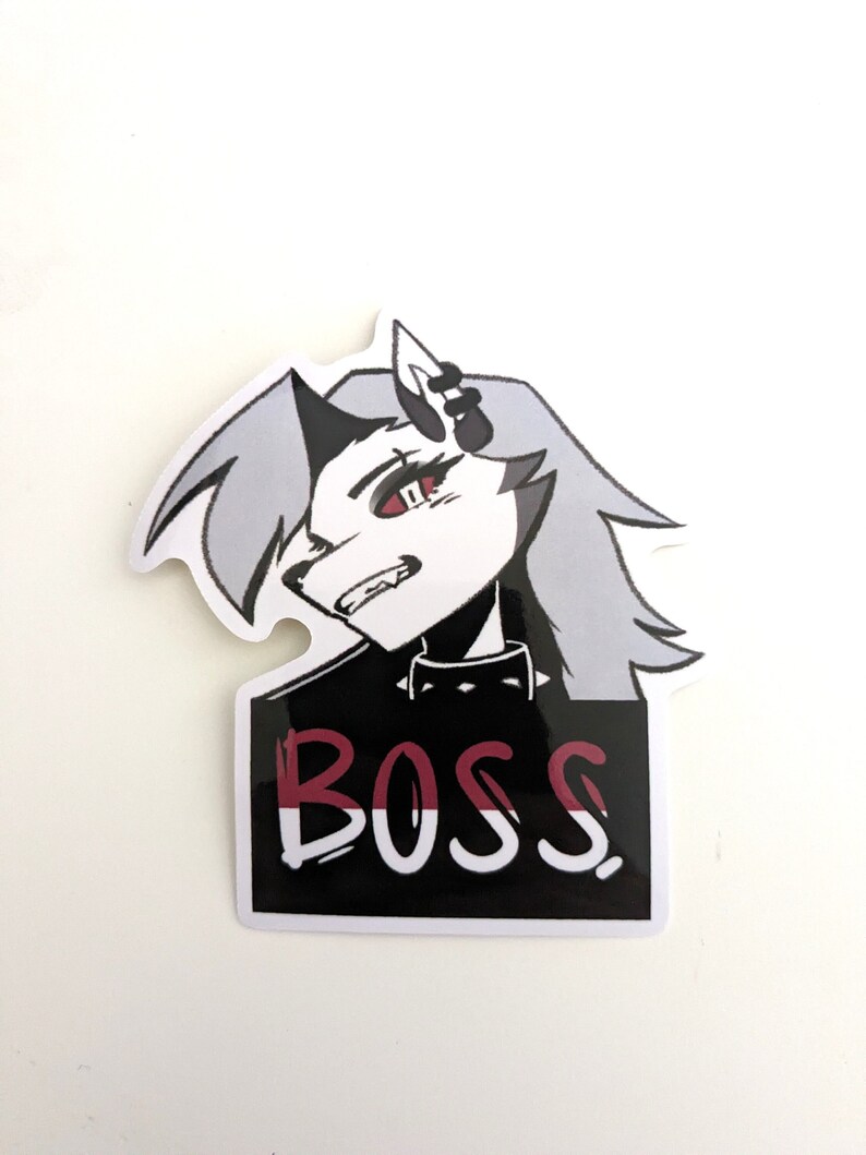 May include: A black and white sticker with a cartoon image of a wolf-like character with red eyes and the word "BOSS" written in red and white letters.