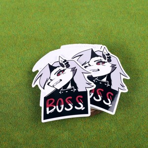 May include: Two white stickers with a black and white illustration of a cartoon character with red eyes and the word "BOSS" printed in red and white on a black background.