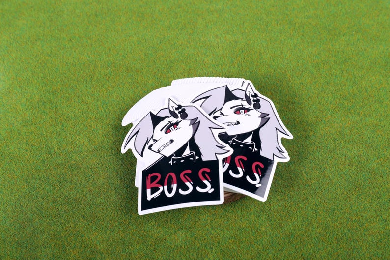 May include: Two white stickers with a black and white illustration of a cartoon character with red eyes and the word "BOSS" printed in red and white on a black background.