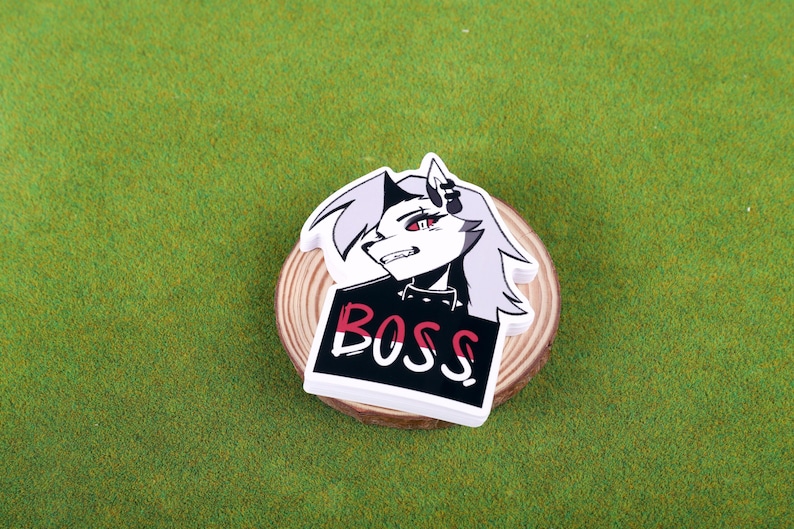 May include: White and black sticker with a cartoon character with red eyes and the word "BOSS" in red and white letters.