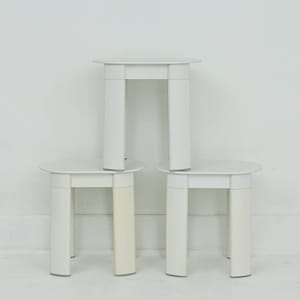 May include: A white ceramic mug with a black handle and the text "But First, Coffee" in a bold, black font. The mug is set against a blurred background, suggesting a cozy setting. The mug appears to be approximately 4 inches tall.