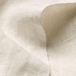 May include: Close-up of off-white woven fabric with a textured surface. The fabric is folded, revealing variations in light and shadow. The weave appears tight and durable, suggesting a natural fiber textile.