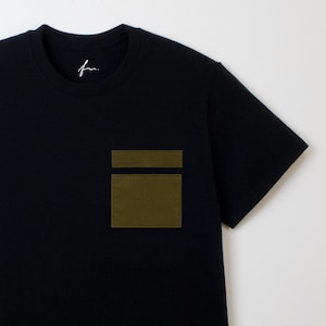 Peut inclure: Un t-shirt noir avec une grande poche plaquée vert olive sur le côté gauche de la poitrine.