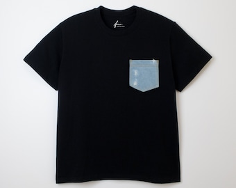 Camiseta negra con bolsillo vaquero. Parche de mezclilla azul claro desgastado. Corte recto. Unisex.