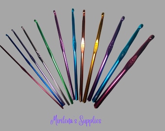 May include: A selection of metallic crochet hooks in a range of sizes and vibrant colours, including blue, green, purple, and gold. The hooks are arranged in a fan shape. The text "Mirilena's Supplies" is written in purple script.
