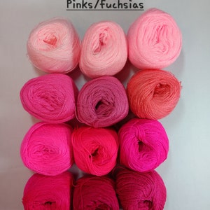 May include: A collection of 10 balls of yarn in shades of pink and fuchsia. The yarn is arranged in a gradient from light pink to dark fuchsia.