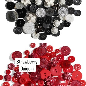 May include: A collection of black, white, and red buttons. The buttons are of various shapes and sizes. The text "Neutrality" and "Strawberry Daiquiri" are visible in the image.