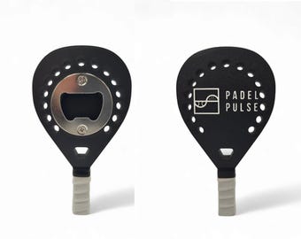May include: Black paddle-shaped bottle opener with a silver bottle opener on one side and the text "PADEL PULSE" on the other side.