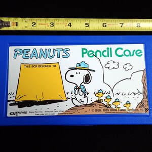 Vintage Peanuts pencil case. Features Snoopy as scoutmaster with Woodstock and friends as cub scouts. Very good condition.