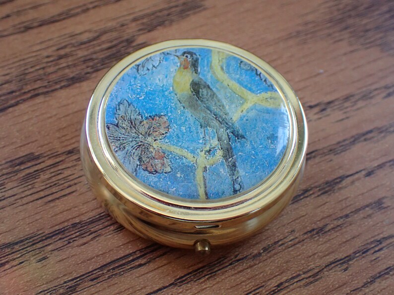 Round White Pill With A Bird On It