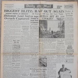 May include: A vintage newspaper page from the Daily Mail, dated November 20, 1943, with headlines about World War II events. The headlines include "Biggest Blitz: RAF Out Again" and "Berlin Hit by 350".