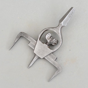 May include: A silver metal circle cutter with a pointed tip and two adjustable arms. The tool is marked "ADJUSTABLE" and "BRAND".