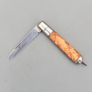 May include: A trio of ceramic mugs with a speckled, matte finish in cream, light grey, and dark grey. Each mug features a simple, modern design and a rounded handle. Ideal for tea or coffee.