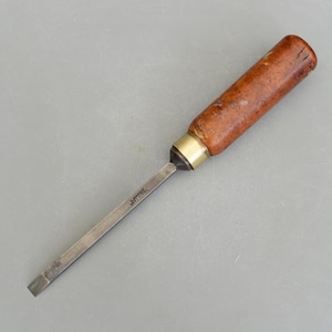 May include: A wooden handled chisel with a metal blade. The blade is marked "Robert Sorby".