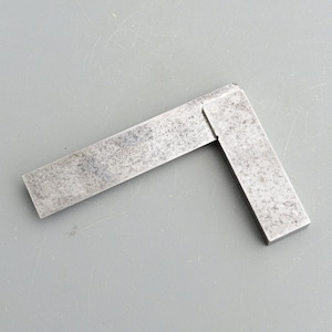 May include: A vintage steel try square with the inscription "INSPECTION" and "J.W. SWITZER & CO. LONDON" on the blade.