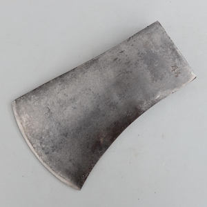 May include: A vintage, curved blade axe head with a weathered, metallic finish. The axe head is marked with the number "4 1/2". The blade has a slight curve and a sharpened edge, suggesting it was used for chopping or splitting wood. The overall appearance is rustic.