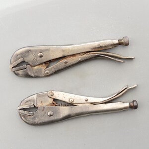 May include: Two silver-toned adjustable pliers with a black handle. The pliers are made by the brand "VICE" and have a "Made in England" label.