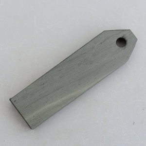 May include: A dark grey rectangular sharpening steel with a rounded end and a hole in the centre.