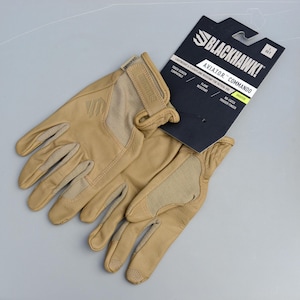 May include: A pair of tan leather gloves with reinforced patches and the text "BLACKHAWK! AVIATOR COMMANDO". The gloves are lightweight, flame resistant, and touch screen compatible. They feature a no-catch trigger finger.