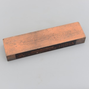 May include: A brown rectangular sharpening stone with the text "Morton Abrasives" and "India" printed on the label.