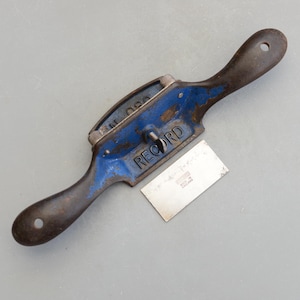 May include: A blue Record brand smoothing plane with a black handle and a silver blade. The blade is labelled "RECORD MADE IN ENGLAND".