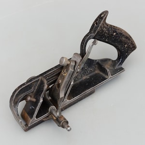 May include: A rustic wooden sign with the text "Welcome to our home" in white lettering. The sign has a distressed finish and a simple, inviting design, suitable for a front porch or entryway.